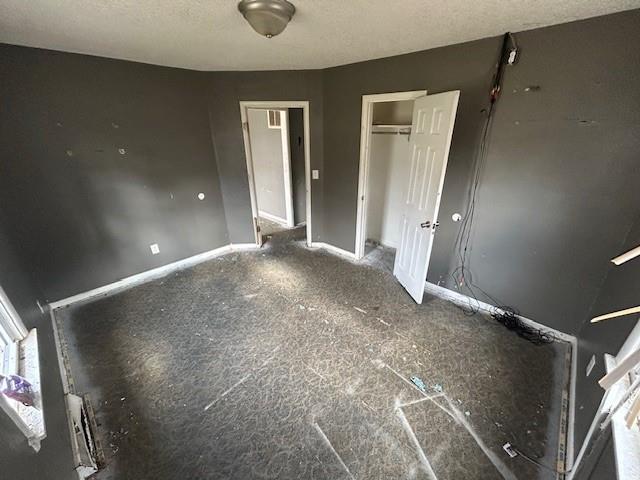 unfurnished bedroom with a textured ceiling