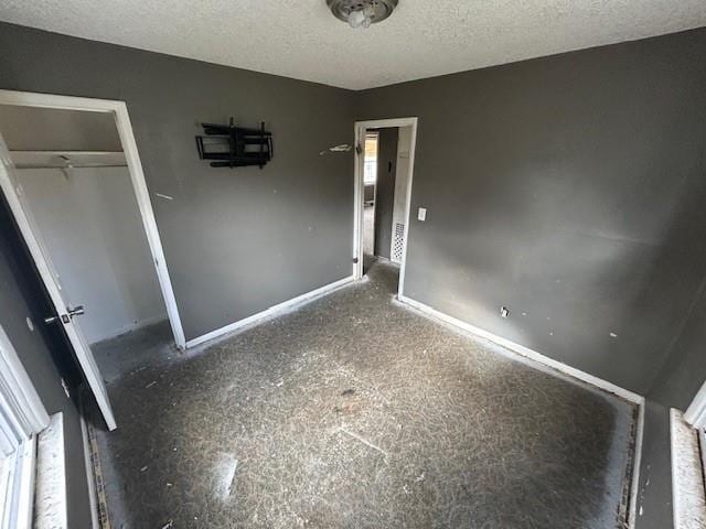 unfurnished bedroom with a textured ceiling and a closet