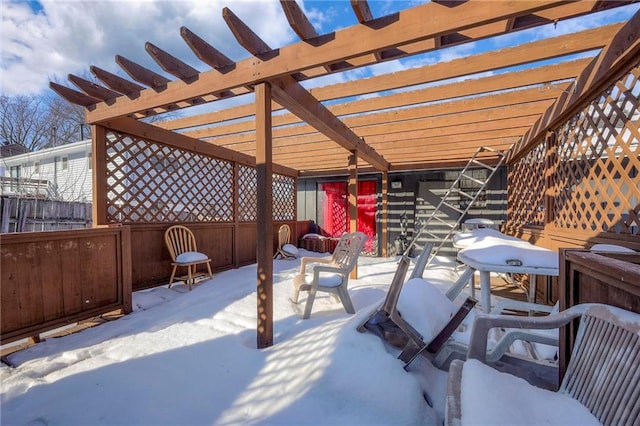 snow covered patio with a pergola