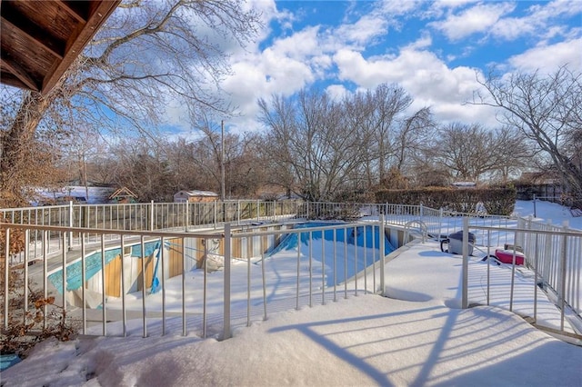 snow covered pool with a patio