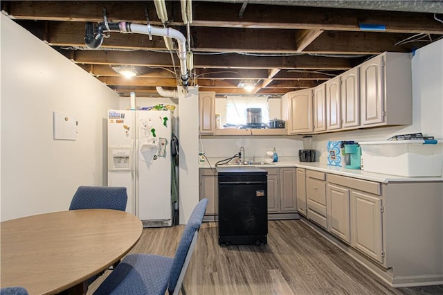 kitchen featuring a sink, white refrigerator with ice dispenser, light countertops, gray cabinets, and dark wood-style floors