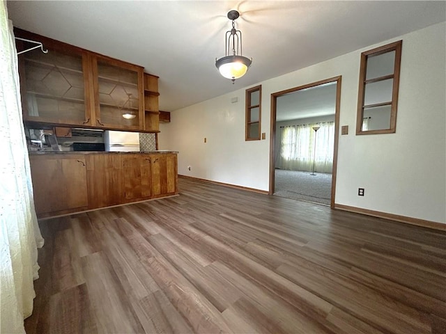 interior space with baseboards and dark wood-type flooring