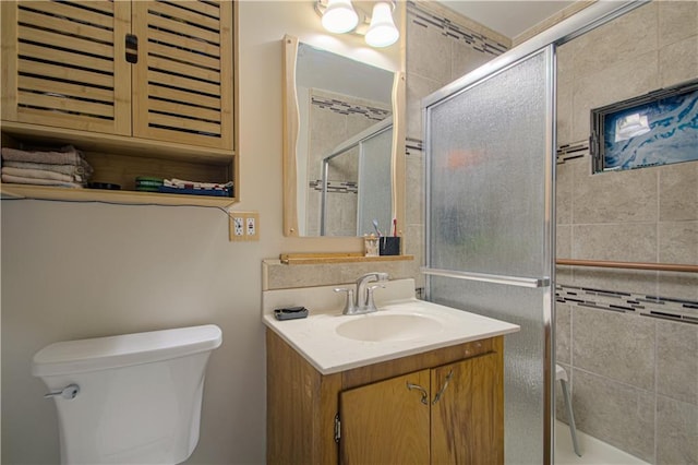 full bathroom with vanity, toilet, and a stall shower