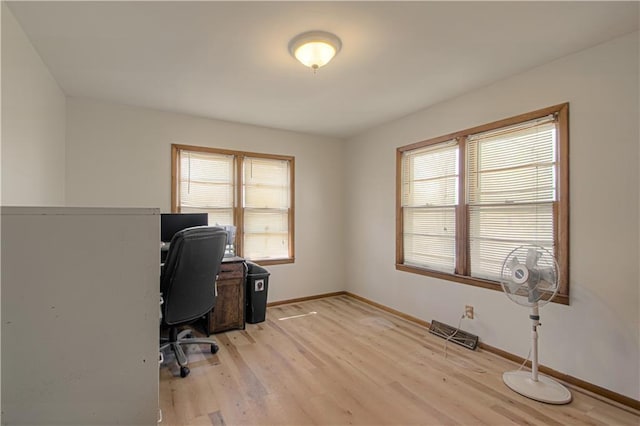 home office with baseboards and light wood finished floors
