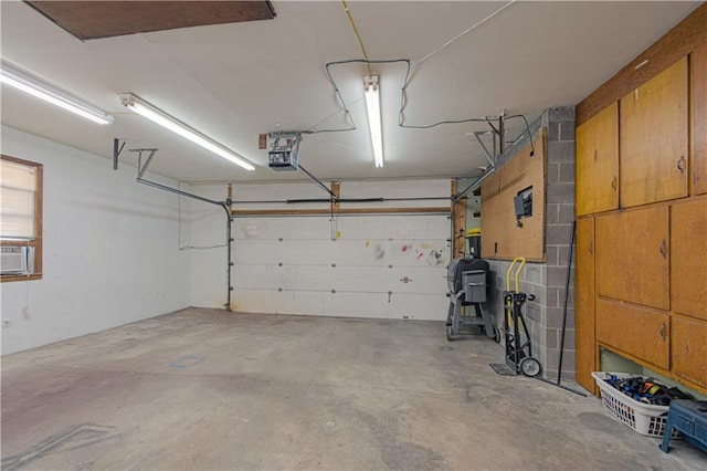 garage with a garage door opener and cooling unit