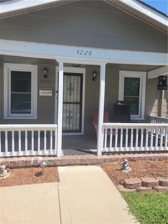 view of exterior entry with covered porch