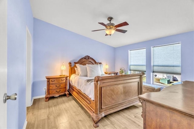 bedroom with ceiling fan and light hardwood / wood-style flooring