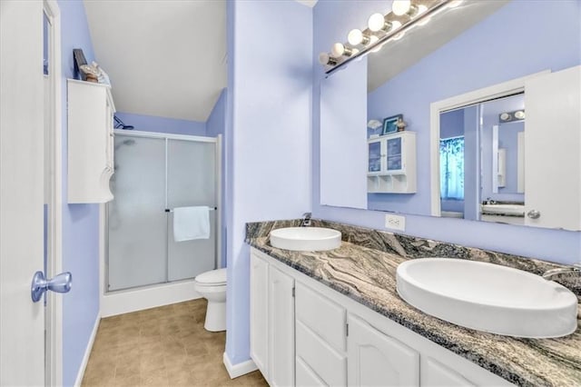 bathroom featuring vanity, a shower with door, and toilet