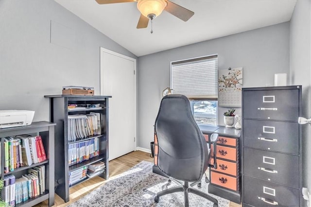 office featuring ceiling fan, lofted ceiling, and light wood-type flooring