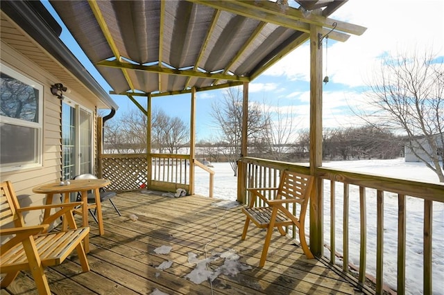 snow covered deck with a pergola