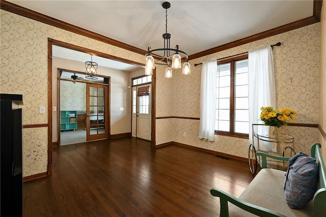 interior space featuring french doors, an inviting chandelier, crown molding, and dark hardwood / wood-style floors