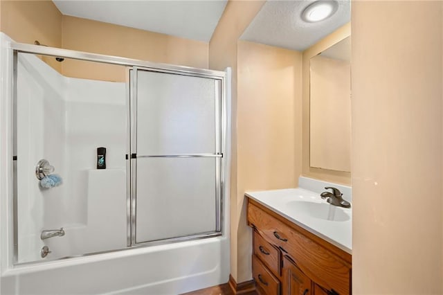 bathroom with vanity and combined bath / shower with glass door