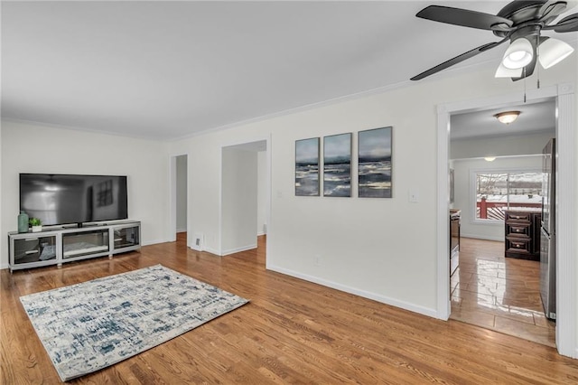 living room with hardwood / wood-style flooring and ceiling fan