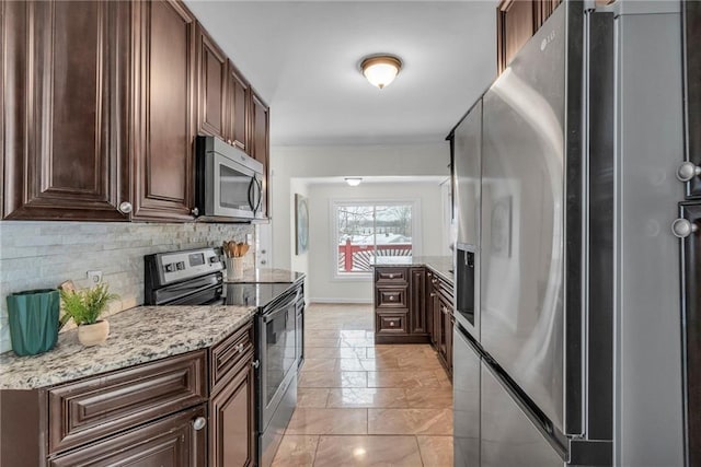 kitchen featuring crown molding, appliances with stainless steel finishes, dark brown cabinetry, light stone counters, and decorative backsplash