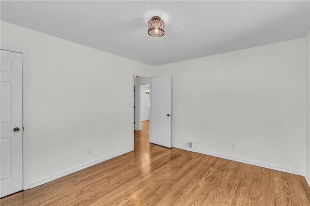 empty room with light hardwood / wood-style flooring