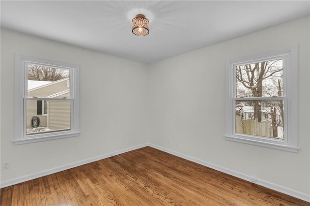 spare room with hardwood / wood-style floors