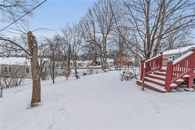 yard layered in snow with a deck