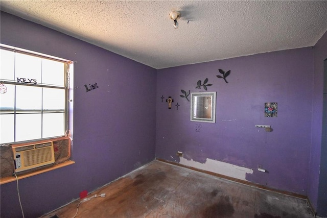 interior space featuring cooling unit and a textured ceiling