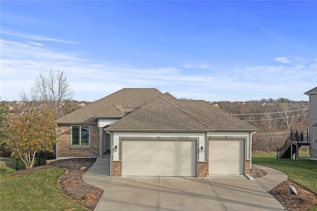 view of front of property featuring a front yard and a garage