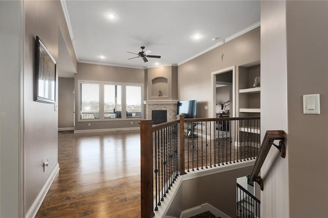 hallway with hardwood / wood-style flooring and ornamental molding