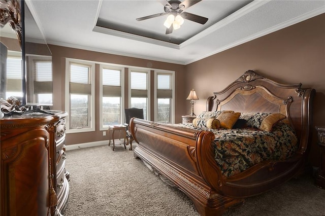 bedroom with a raised ceiling, ceiling fan, crown molding, and carpet floors