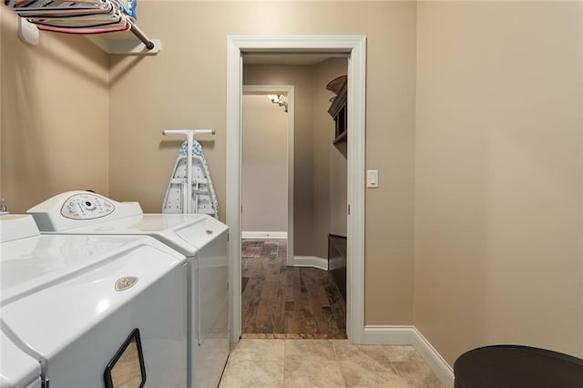 laundry area with light wood-type flooring and separate washer and dryer