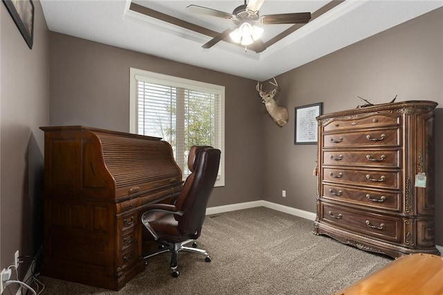 office area with carpet, a raised ceiling, ceiling fan, and ornamental molding