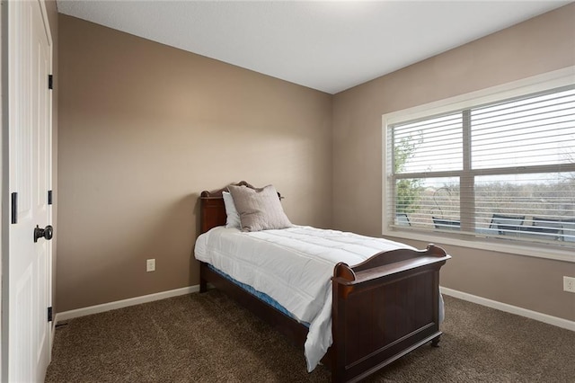 bedroom featuring dark carpet