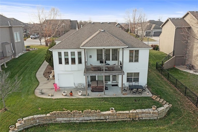 back of house featuring a yard, a patio, and a balcony