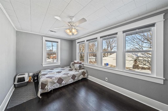 bedroom featuring dark hardwood / wood-style floors, ceiling fan, and ornamental molding