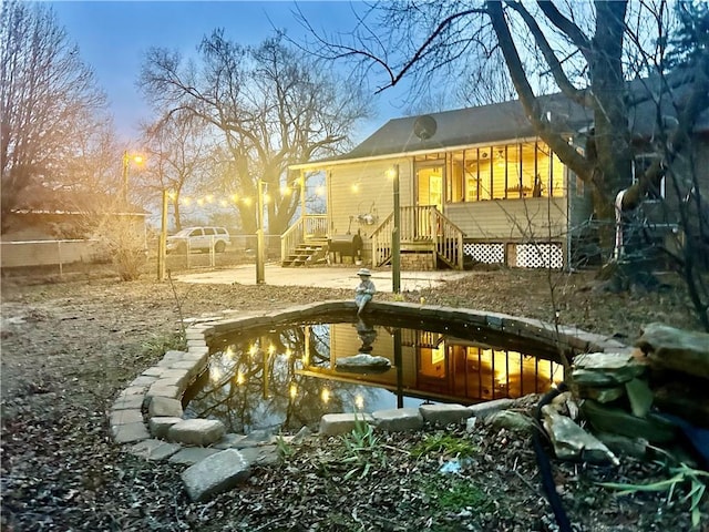 view of back house at dusk