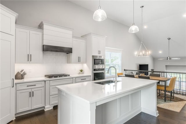 kitchen with sink, ceiling fan, an island with sink, decorative light fixtures, and white cabinetry