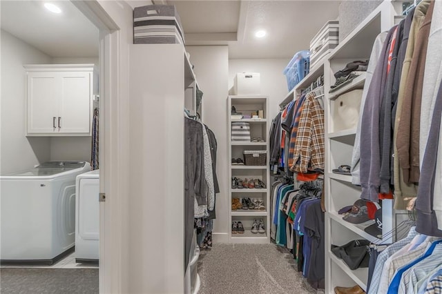 spacious closet featuring carpet flooring and washing machine and dryer