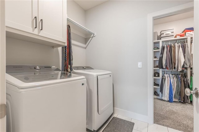 laundry area with separate washer and dryer, light tile patterned flooring, and cabinets