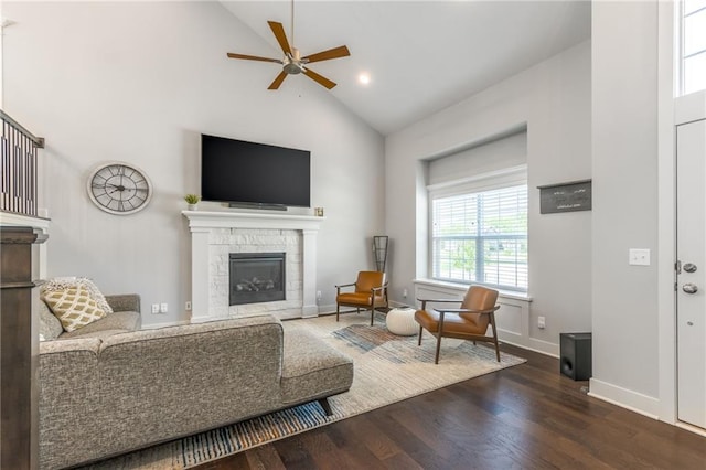 1116 SW Whispering Willow Way, Lees Summit, MO 64064 - living room featuring high vaulted ceiling, a glass covered fireplace, ceiling fan, wood finished floors, and baseboards
