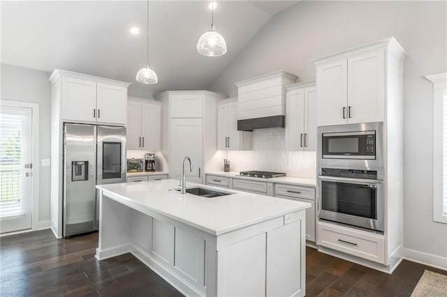 1116 SW Whispering Willow Way, Lees Summit, MO 64064 - kitchen featuring stainless steel appliances, a sink, a center island with sink, dark wood-type flooring, and light countertops