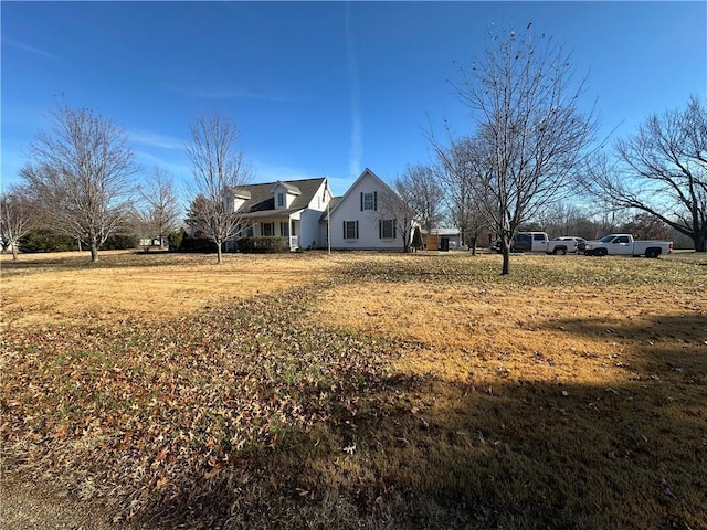 view of side of home with a yard