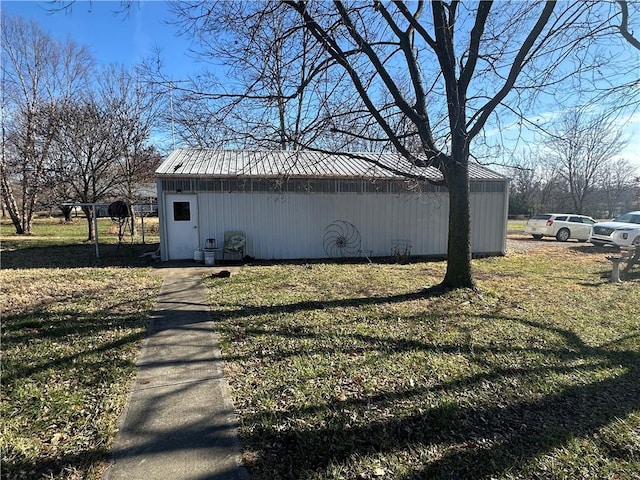 view of side of property with a yard