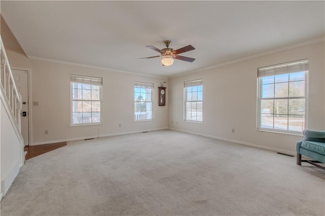 interior space with ceiling fan and crown molding