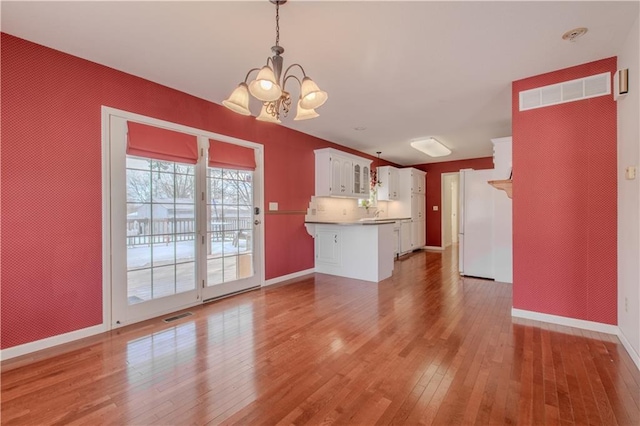 interior space featuring hardwood / wood-style flooring and a notable chandelier