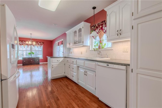 kitchen featuring sink, white appliances, white cabinets, and tasteful backsplash