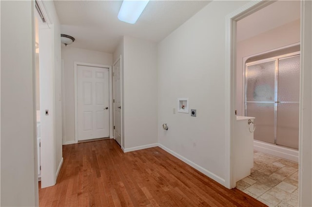 clothes washing area with light hardwood / wood-style floors, gas dryer hookup, hookup for a washing machine, and hookup for an electric dryer