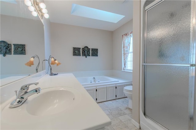 full bathroom with toilet, a skylight, plus walk in shower, and sink