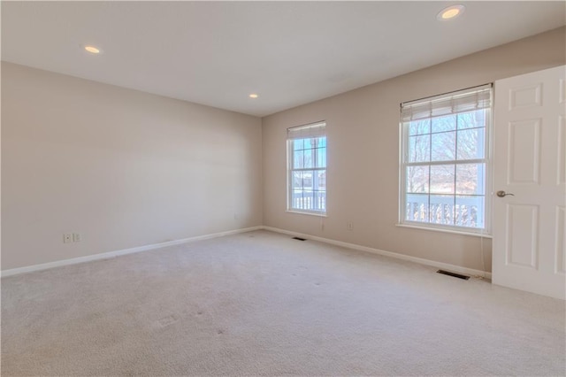 empty room featuring light carpet