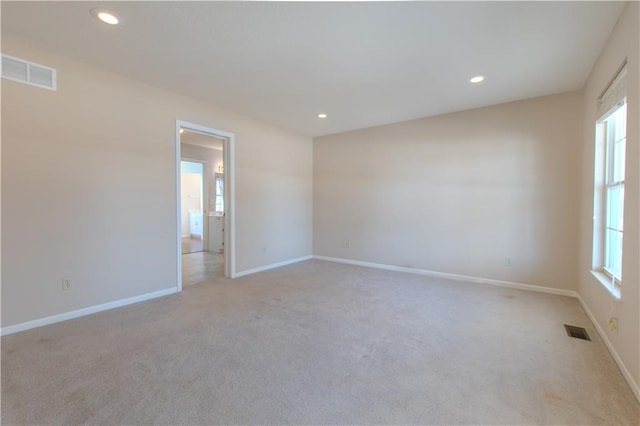 unfurnished room with light colored carpet