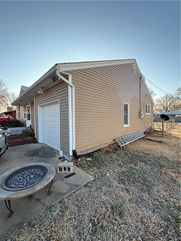 view of side of home featuring a garage