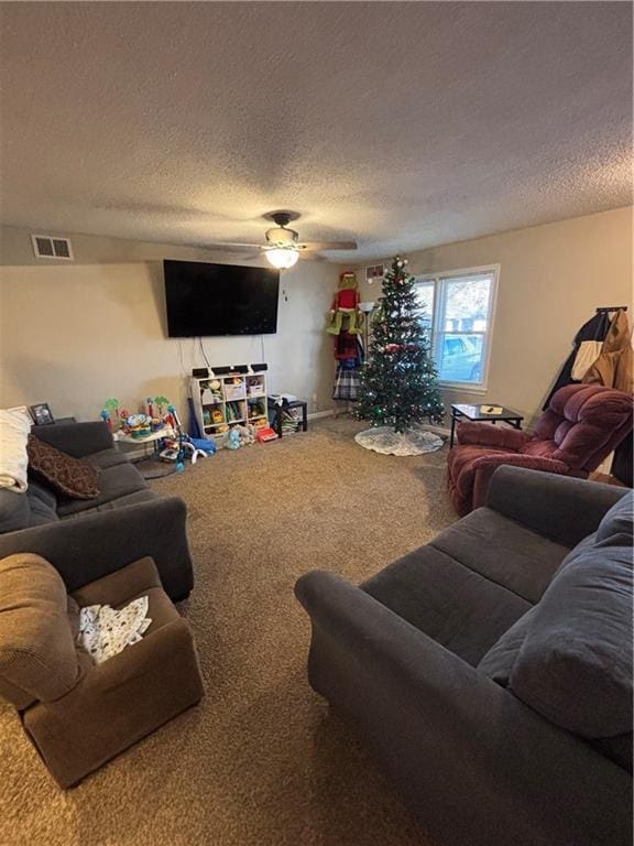 carpeted living room with a textured ceiling and ceiling fan