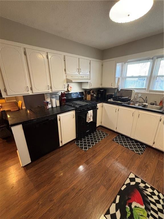 kitchen with black appliances, white cabinets, sink, a textured ceiling, and dark hardwood / wood-style flooring