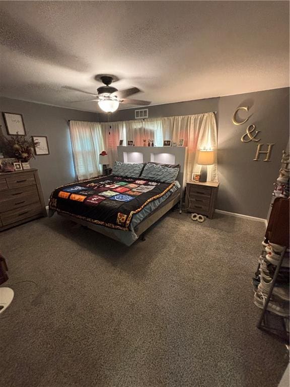 bedroom featuring carpet flooring, ceiling fan, and a textured ceiling