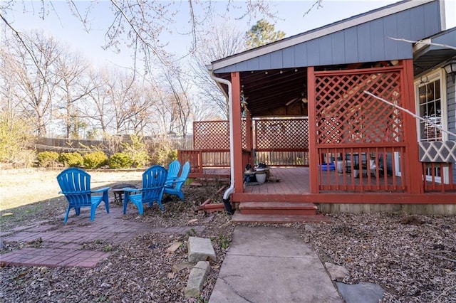 wooden terrace with a patio area and an outdoor fire pit